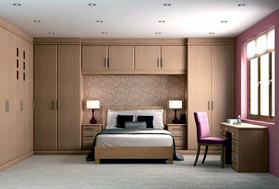 Contemporary beech style fitted bedroom with built in wardrobes 